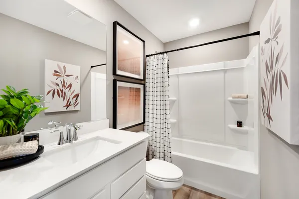 a bathroom with a sink a toilet a glass door a shower and a mirror