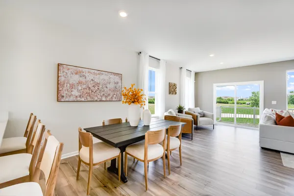 a dining room with furniture and wooden floor
