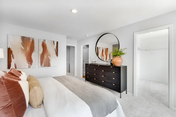 a bedroom with a bed and a dresser