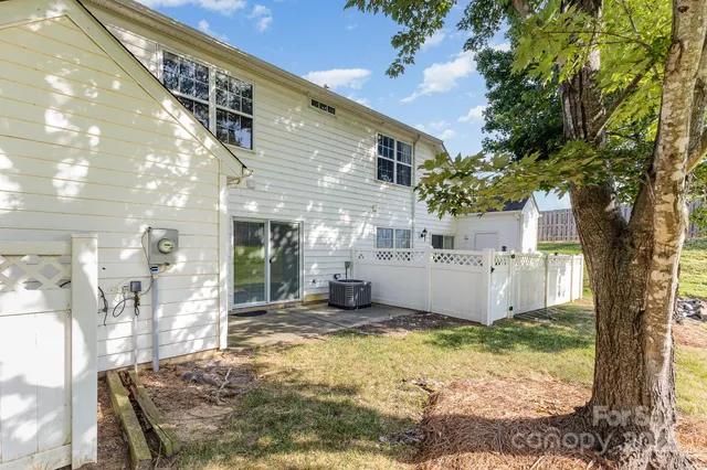 a view of a yard with wooden fence