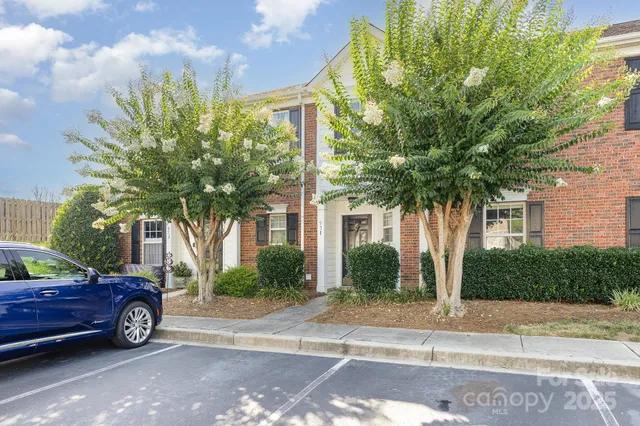 a view of a car parked in front of a brick house