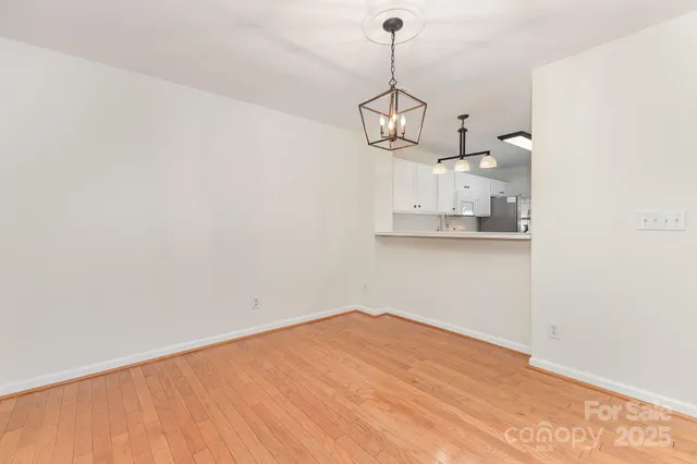 a view of an empty room with a fireplace and a window