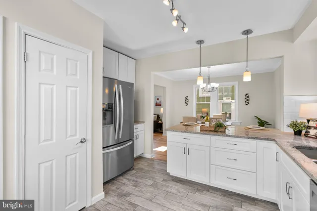 a kitchen with a refrigerator and a sink