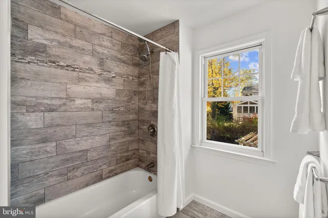 a bathroom with a bathtub and a shower
