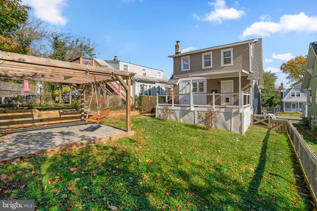 a view of a house with a big yard and large trees