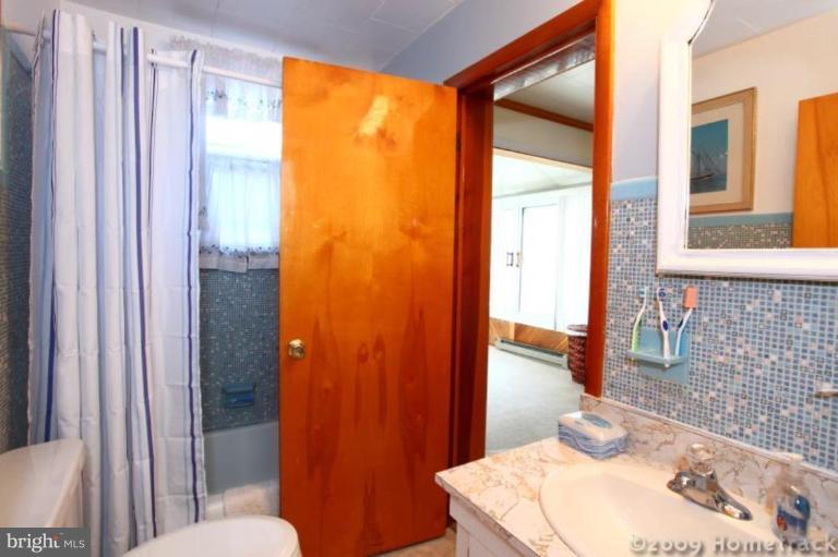216 Nanticoke Road Essex, MD 21221 - Photo 19 of 19 a bathroom with a sink and a mirror