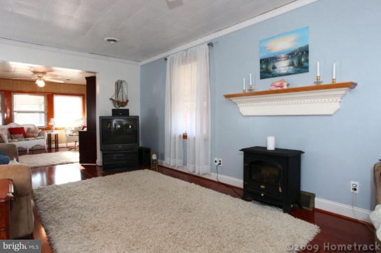 216 Nanticoke Road Essex, MD 21221 - Photo 3 of 19 a bedroom with a bed and a dresser