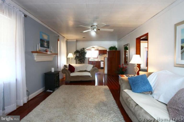 216 Nanticoke Road Essex, MD 21221 - Photo 4 of 19 a living room with furniture and a chandelier