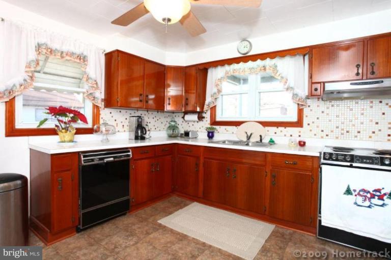 216 Nanticoke Road Essex, MD 21221 - Photo 5 of 19 a kitchen with stainless steel appliances granite countertop a sink stove and cabinets