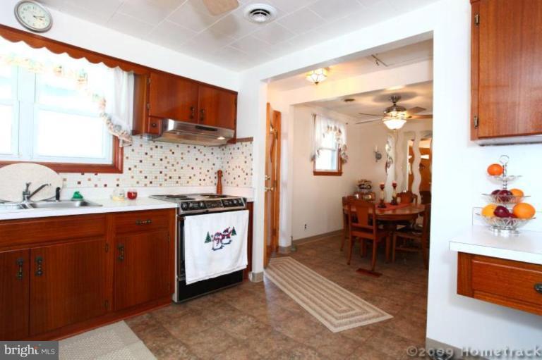 216 Nanticoke Road Essex, MD 21221 - Photo 6 of 19 a kitchen with stainless steel appliances kitchen island granite countertop a sink and cabinets