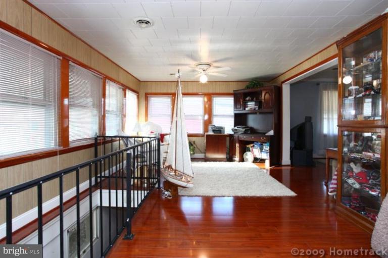 216 Nanticoke Road Essex, MD 21221 - Photo 7 of 19 a view of a dining room with furniture window and wooden floor