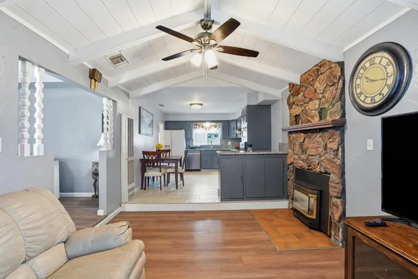 a living room with furniture a clock and a flat screen tv