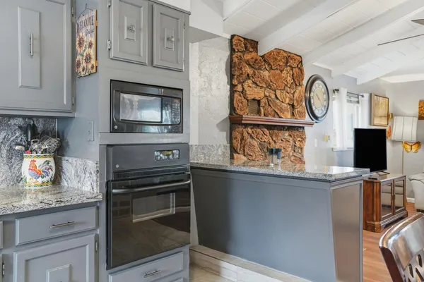 a kitchen with stainless steel appliances granite countertop a stove and a microwave
