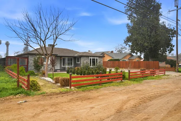 a view of a house with a yard patio and sitting area