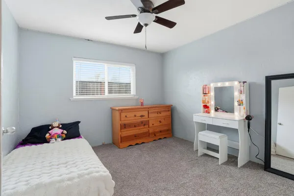a bedroom with a bed and a desk