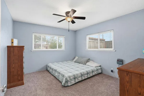 a bedroom with a bed and window