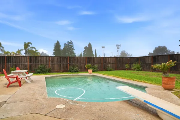 a view of a swimming pool with a yard