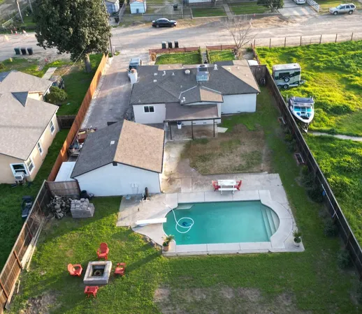 an aerial view of a house with garden space ocean view