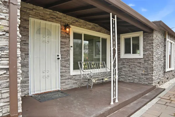 a porch with seating space and glass door