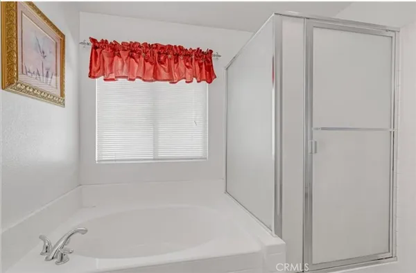 a white bath tub sitting next to a white cabinet
