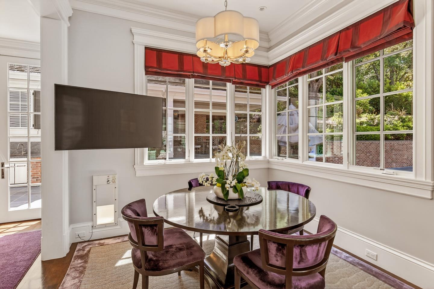 351 Walsh Road Atherton, CA 94027 - Photo 12 of 65 a dining room with furniture a potted plant and a chandelier