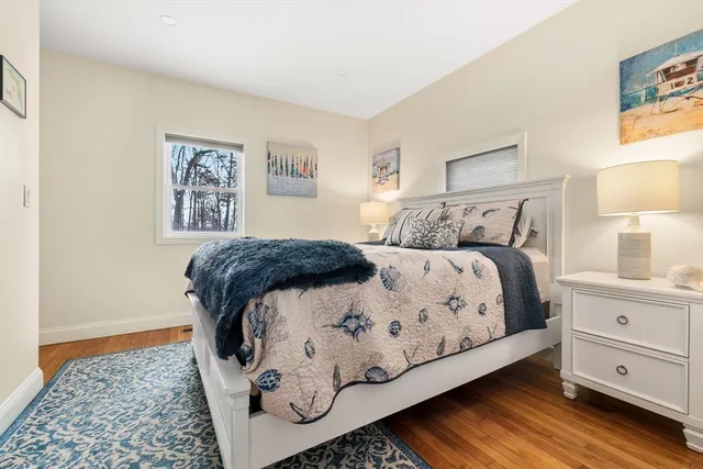 a bedroom with a bed and a night stand