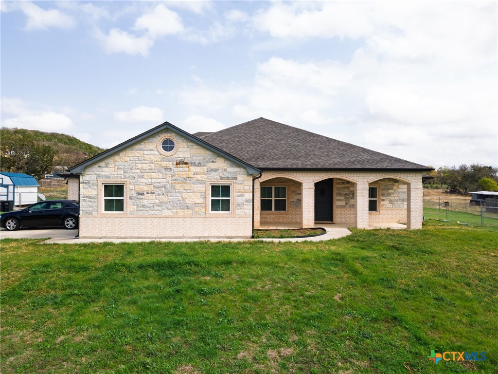 a front view of house with yard and green space