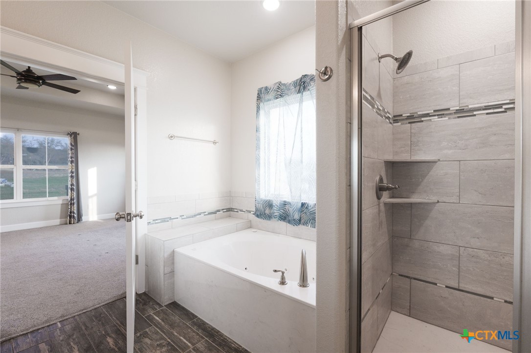 2662 Snow Road Kempner, TX 76539 - Photo 19 of 28 a bathroom with a bathtub and a shower