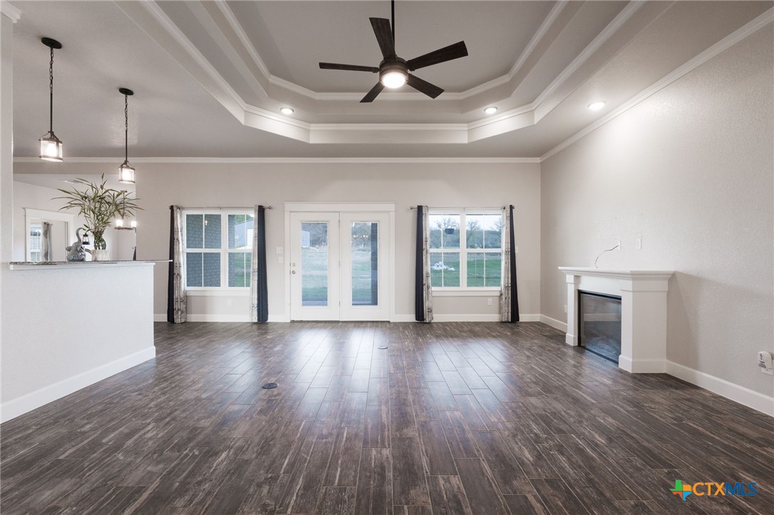 2662 Snow Road Kempner, TX 76539 - Photo 6 of 28 a view of a livingroom with wooden floor a ceiling fan and windows