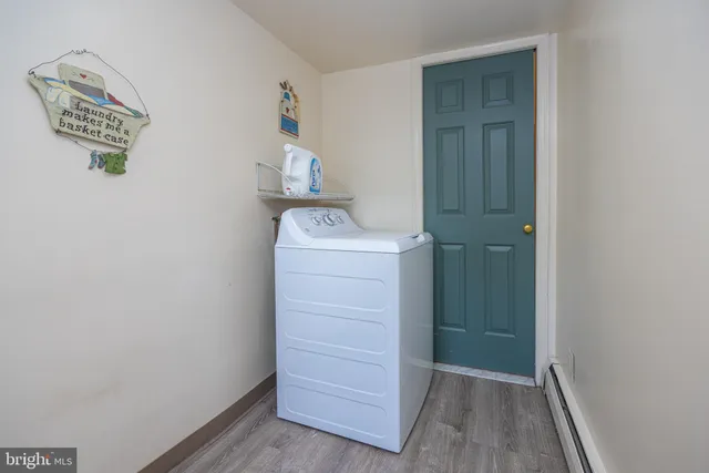 a view of walk in closet with wooden floor