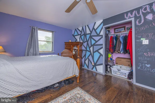 a bedroom with a bed and a wooden floor