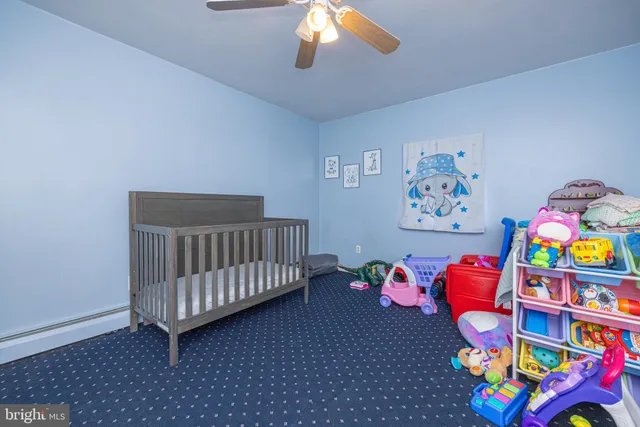 a bedroom with baby toys and dresser