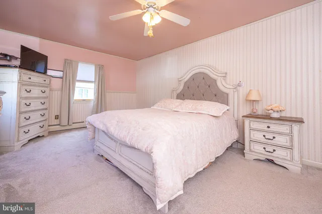 a spacious bedroom with a bed and a cabinets