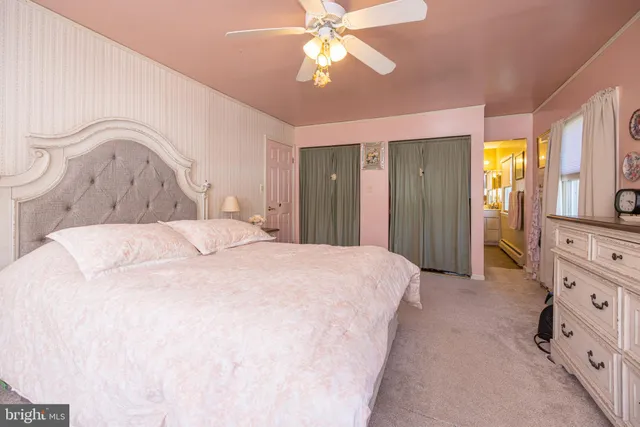 a spacious bedroom with a bed and a chandelier