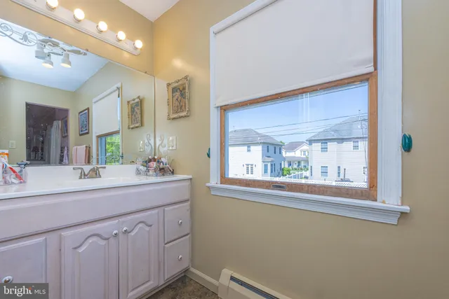a bathroom with a sink vanity and mirror