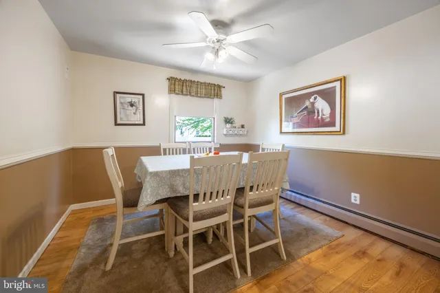 a view of a dining room with furniture and a large window