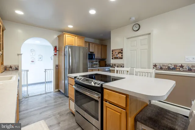 a kitchen with a refrigerator and a stove