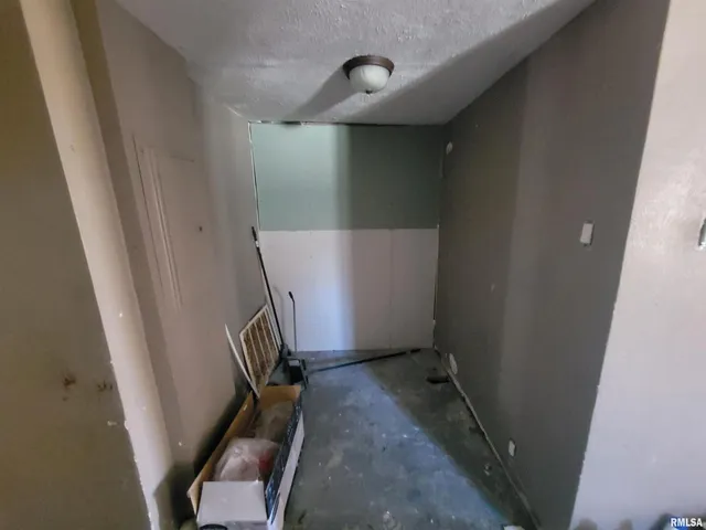a bathroom with a granite countertop toilet and a sink