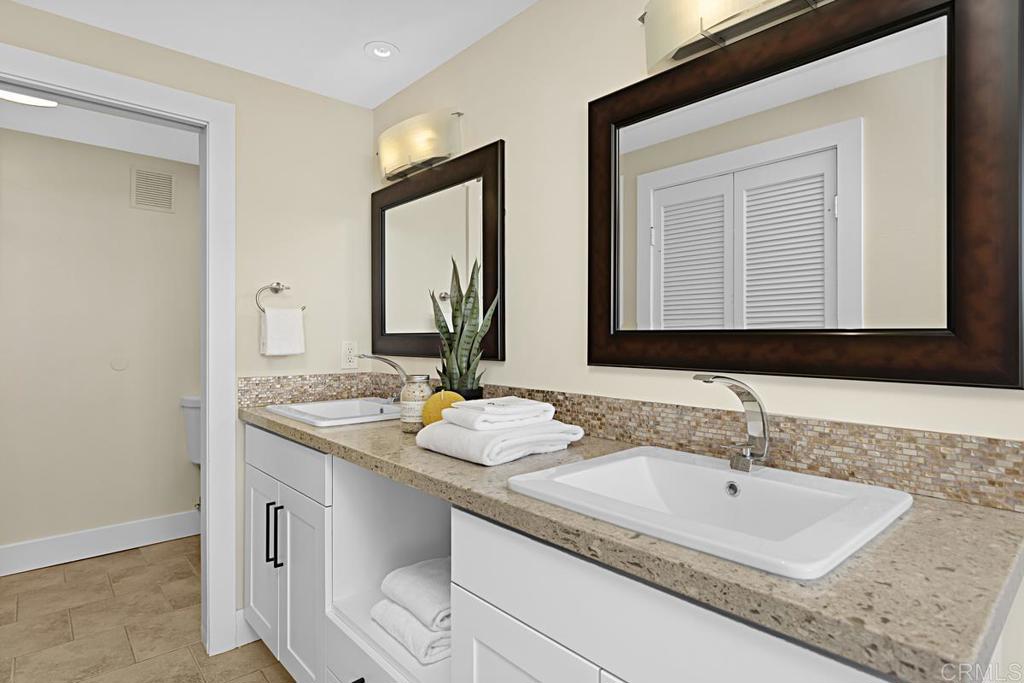 2500 Torrey Pines Road, Unit 503 La Jolla, CA 92037 - Photo 19 of 46 a bathroom with a granite countertop sink and a mirror