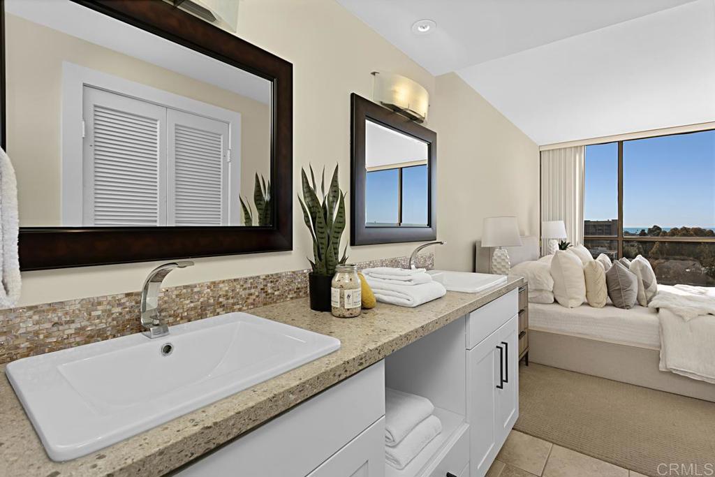 2500 Torrey Pines Road, Unit 503 La Jolla, CA 92037 - Photo 21 of 46 a bathroom with a double vanity sink and mirror