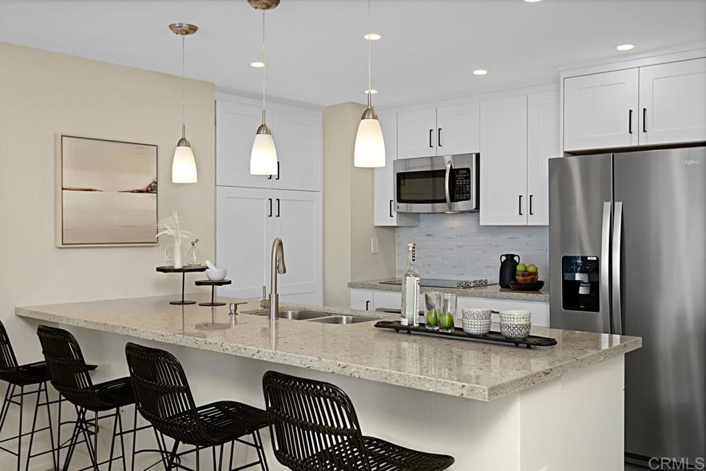 2500 Torrey Pines Road, Unit 503 La Jolla, CA 92037 - Photo 9 of 46 a kitchen with stainless steel appliances granite countertop a sink refrigerator and microwave