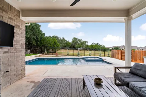 a view of swimming pool with seating space and furniture