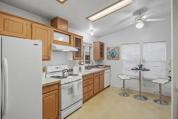a kitchen with cabinets and chairs