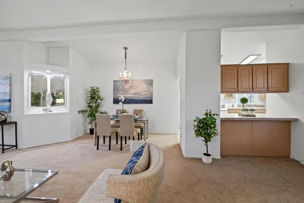a living room with furniture a piano and a window