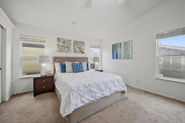 a bedroom with a bed and a window