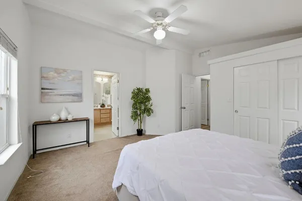a bedroom with a large bed dresser and a window
