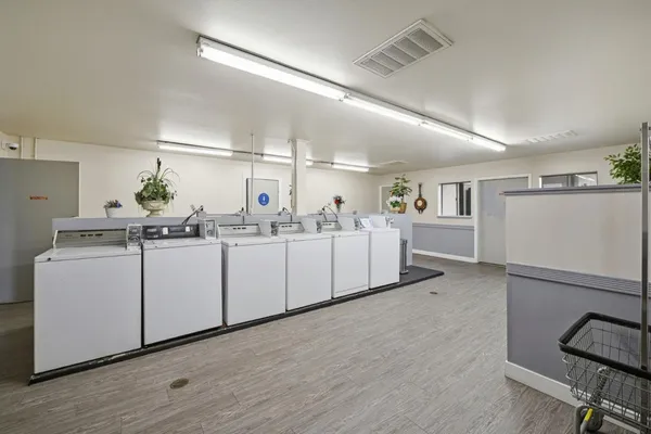 a kitchen with white cabinets and sink