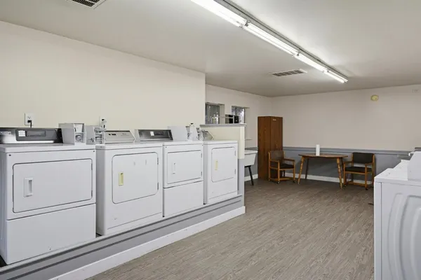 a utility room with cabinets dryer and washer