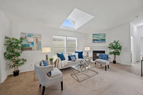 a living room with furniture potted plant and a fireplace
