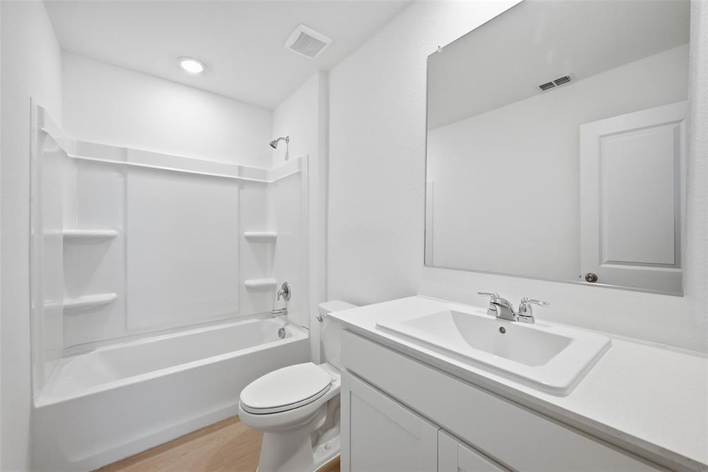 1613 Elliott Road Howe, TX 75459 - Photo 13 of 19 a bathroom with a sink a toilet and a bathtub